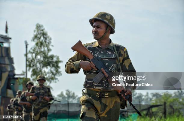 Border Security Force personnel patrolling along the barbed wire fence at India-Pakistan border during Independence Day celebrations at RS Pura...