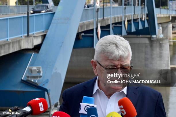 Politician of the Greens and former German Foreign Minister Joschka Fischer stands in front of the so-called Stadtbruecke bridge crossing the river...