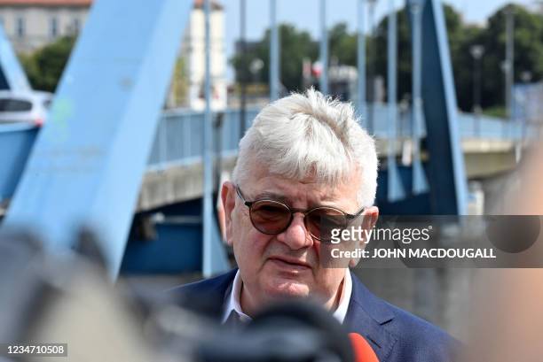 Politician of the Greens and former German Foreign Minister Joschka Fischer stands in front of the so-called Stadtbruecke bridge crossing the river...