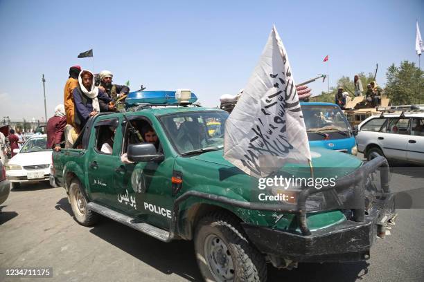 Taliban fighters patrol the streets of Kabul on August 16 after a stunningly swift end to Afghanistan's 20-year war, as thousands of people mobbed...