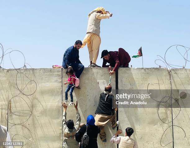 Thousands of Afghans rush to the Hamid Karzai International Airport as they try to flee the Afghan capital of Kabul, Afghanistan, on August 16, 2021.