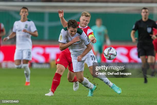 Jean Zimmer of 1. FC Kaiserslautern and Joseph Michael Scally of Borussia Moenchengladbach battle for the ball during the DFB Cup first round match...