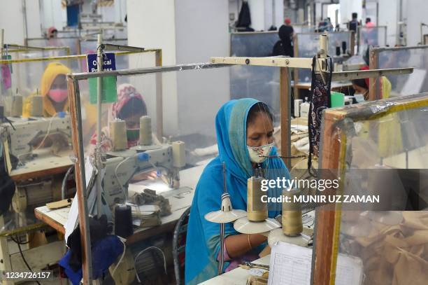 Labourers work at their stations separated by partitions as a preventive measure against the Covid-19 coronavirus at the Civil Engineers Limited...