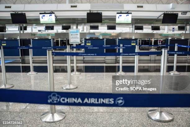 View of a deserted check-in counter at Hong Kong International Airport.