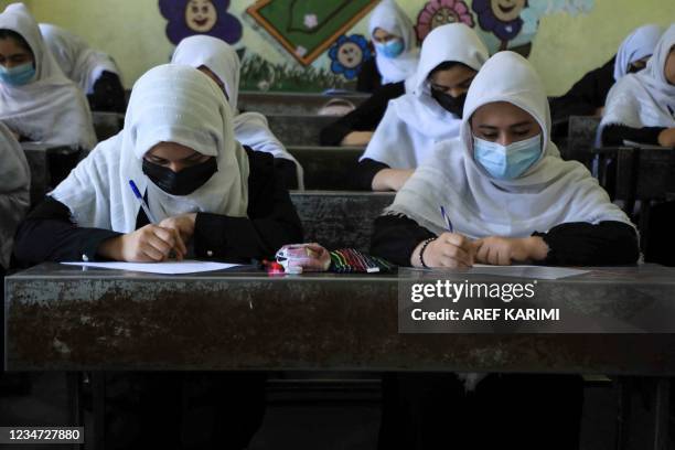 Schoolgirls attend class in Herat on August 17 following the Taliban stunning takeover of the country.