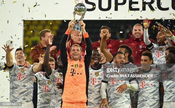 Bayern Munich's German goalkeeper Manuel Neuer lifts the trophy after the German Supercup football match BVB Borussia Dortmund vs FC Bayern Munich in...