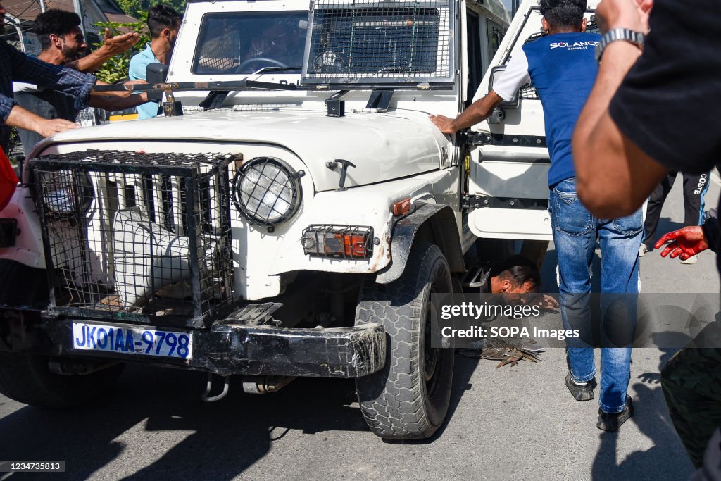 An Indian police vehicle running over a Shia mourner, during...
