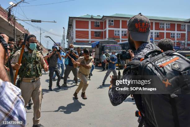Police officer seen attacking Kashmiri journalists during a Muharram procession in Srinagar. Authorities imposed restrictions in parts of Srinagar...