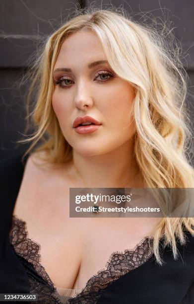 In this image released on August 17, US actress and plus size model Hayley Amber Hasselhoff wearing a black long flared v-neck dress with lace detail...