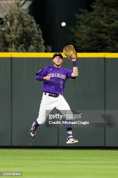 Garrett Hampson of the Colorado Rockies makes a leaping catch to end the game against the San Diego Padres during the ninth inning at Coors Field on...