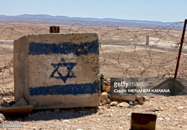 This picture taken from the Israeli side of the frontier, shows an Egyptian army post behind the fence along the border with Israel, in the Negev...