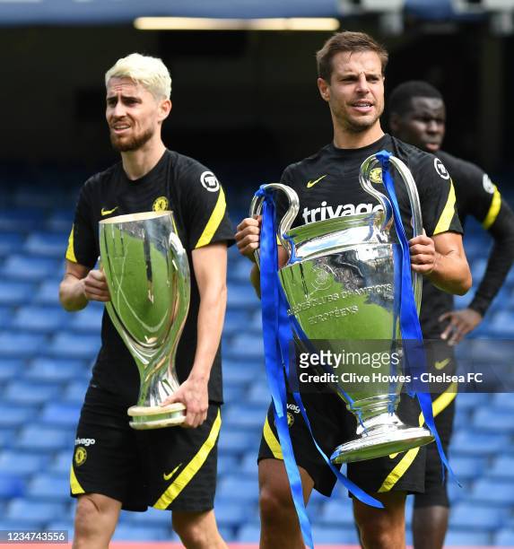 Jorginho and Cesar Azpilicueta of Chelsea parade the Champions League Trophy and the Super Cup Trophy during a Open Chelsea Training Session at...