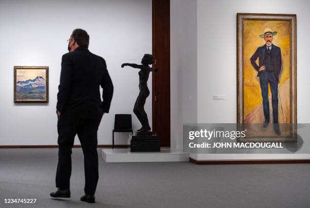 Visitor walks past Swiss painter Ferdinand Hodler's "Dents du Midi", German sculptor Georg Kolbe's "Dancer", and Norwegian painter Edvard Munch's...