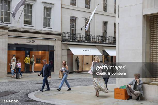 Pedestrians pass luxury boutiques on New Bond Street in London, U.K., on Wednesday, Aug. 18, 2021. U.K. Inflation eased in July in what is widely...