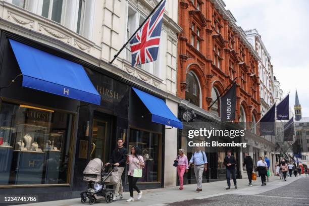 Shoppers pass luxury stores on New Bond Street in London, U.K., on Wednesday, Aug. 18, 2021. U.K. Inflation eased in July in what is widely seen as a...