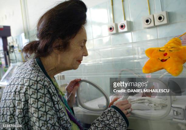 Adriana Iliescu looks at Eliza Maria, her newborn girl, at the intensive care department at the Giulesti Maternity Hospital in Bucharest, 20 January...