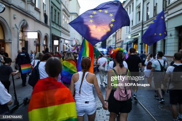 Female members of Polish LGBTQ community are seen holding hands in front of the European Union flag during the march. Annual Equality March also...