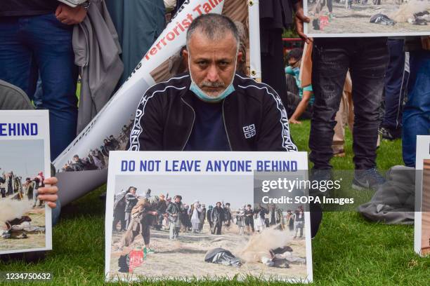 Protester holds a placard with an image of an execution and the message 'Do Not Leave Anyone Behind', during the demonstration in Parliament Square....