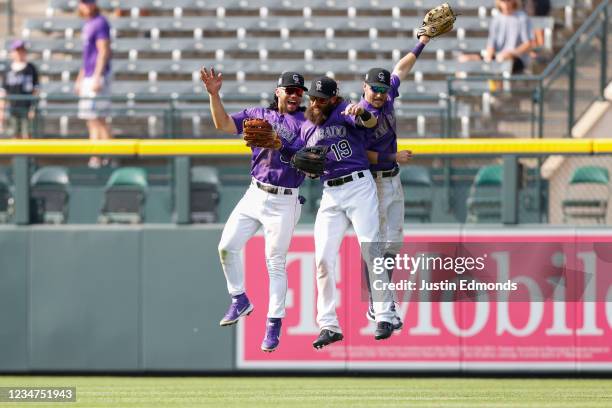 Connor Joe, Charlie Blackmon and Garrett Hampson of the Colorado Rockies celebrate a win against the San Diego Padres at Coors Field on August 18,...