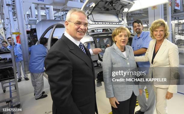 German Chancellor Angela Merkel inspects the production of a Volkswagen car during a visit to the VW plant accompanied by Volkswagen CEO Martin...