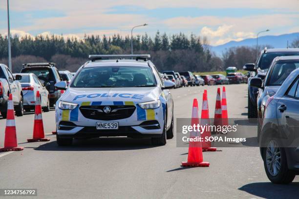 Police vehicle patrols at a drive-thru covid-19 testing station on Orchard Road in Christchurch. New Zealand has so far confirmed 2,954 Coronavirus...