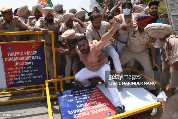 Policemen try to stop Bharatiya Janata Party activists during a protest marchi towards the residence of Punjab Congress president Navjot Singh Sidhu...