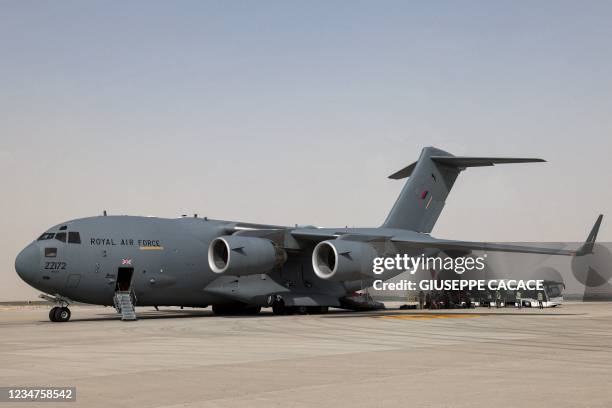 People disembark off a Royal Air Force Boeing C-17A Globemaster III military transport aircraft carrying evacuees from Afghanistan and arriving at...