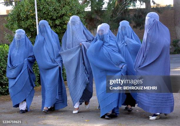 Afghan women teachers arrive at the Azadi Garden in Herat 20 November 2001 to meet with Northern Alliance commander and governor of Herat Ismael...