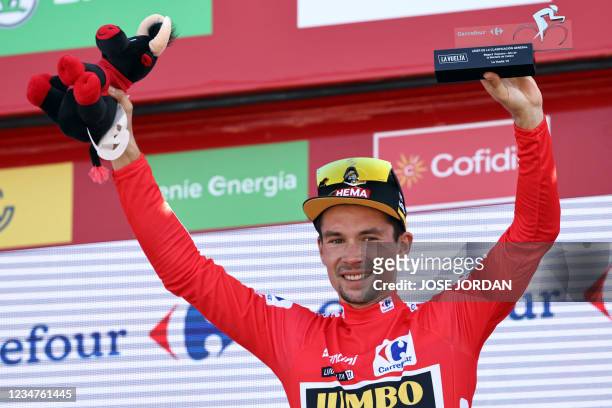 Team Jumbo's Slovenian rider Primoz Roglic celebrates on the podium wearing the overall leader's red jersey after the 6th stage of the 2021 La Vuelta...