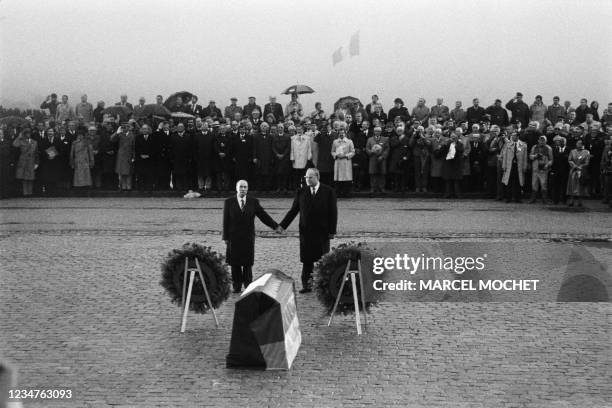 Le président François Mitterrand et le chancelier allemand Helmut Kohl se tiennent la main en écoutant les hymnes nationaux français et allemand lors...