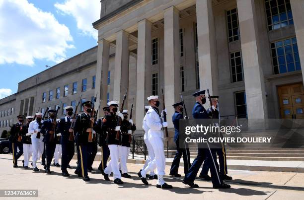 Members of the US armed forces honor guard prepare to welcome Qatari Defense Minister Khalid Bin Mohammed Al-Attiyah to the Pentagon's River Entrance...