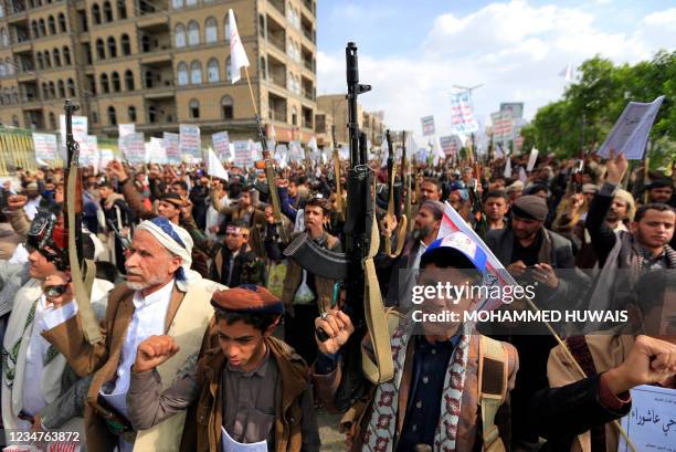 Yemeni Shiite Muslim supporters of the Iran-backed Huthi rebels brandish weapons as they gather to mark the tenth day of the month of Muharram which...