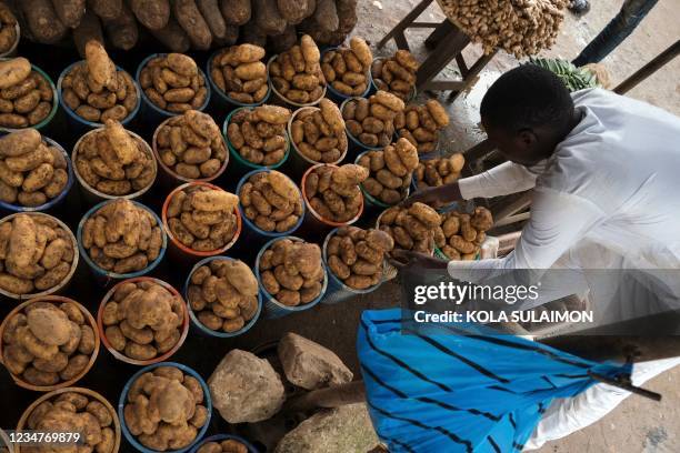 Trader display farm produce at Wuse Market, Abuja, Nigeria, on August 17, 2021. - Threatened by insecurity, farmers in Nigeria's farm belt are...