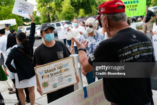 Pro- and anti-mask demonstrators interact at a rally over Cobb School District's optional mask policy in Marietta, Georgia, U.S., on Thursday, Aug....