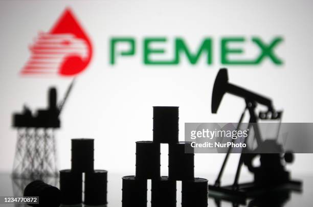 Pemex logo and models of an oil rig, pump jack and oil barrels are pictured in this illustration photo taken in Kyiv on 19 August, 2021.