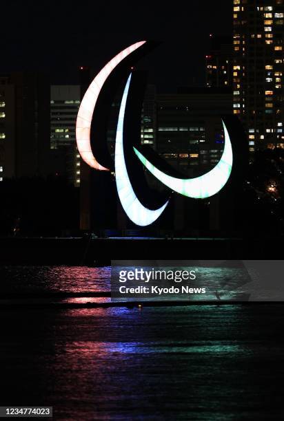The Paralympic three agitos are pictured after being installed in Tokyo's Odaiba waterfront area on Aug. 20 ahead of the opening ceremony of the...