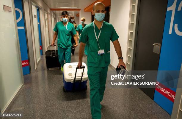 Cardiovascular surgeon Juan Esteban de Villarreal pulls a portable fridge containing a donor's heart to be implanted in a patient at Puerta de Hierro...