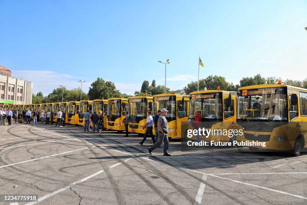 School buses that will be sent to village communities are lined up in the square outside the Odesa Regional State Administration, Odesa, southern...