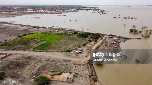 An aerial view of Kelakla region of Khartoum as students try to prevent their school from flood by making barrier with sacks filled with soil after...