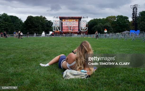 Woman listens during a soundcheck by musicians from Earth, Wind and Fire at Central Park's Great Lawn in New York on August 20 a day before the "We...