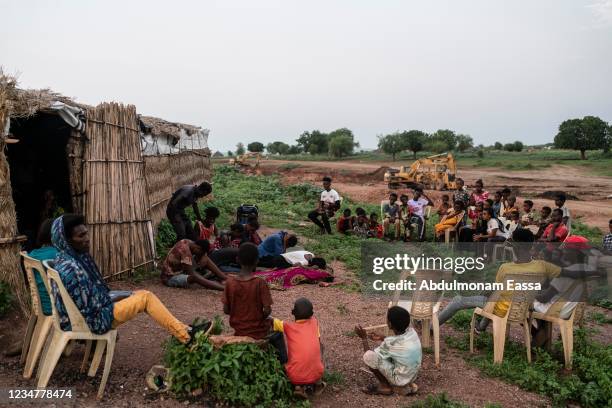 People watch a theatre performance by a group of Tigrayan refugees in the Sudanese village of Um Rakuba, home to over 20,000 refugees, on August 18...