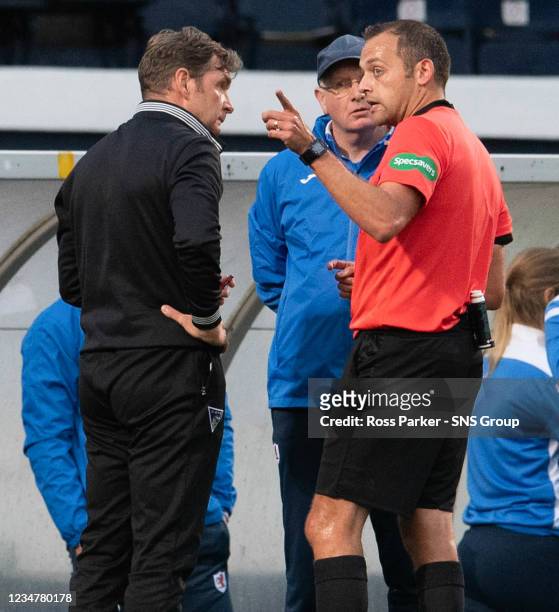 Referee Gavin Duncan speaks to Raith manager John McGlynn and Dunfermline manager Peter Grant as the game is abandoned during the cinch Championship...
