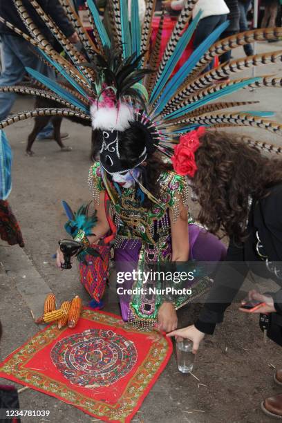 Mexican dancer dressed in an Aztec costume performs a prayer to the spirits of the deceased during celebrations for the Day of the Dead in Toronto,...
