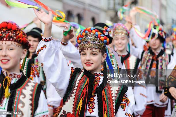 Representatives of Ukraine in traditional clothes walk on street during the Etnovyr 2021 International Folk Festival in western Ukraine. Folklore...