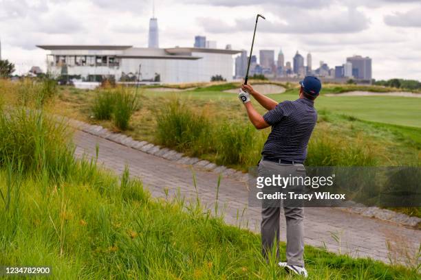 Brian Stuard hits a shot from the other side of the cart path at the 18th hole during the second round of THE NORTHERN TRUST at Liberty National Golf...