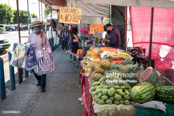 Mexican people wearing face masks went about their daily lives in markets and streets in Puebla, Mexico, on 19 August as coronavirus cases surged due...