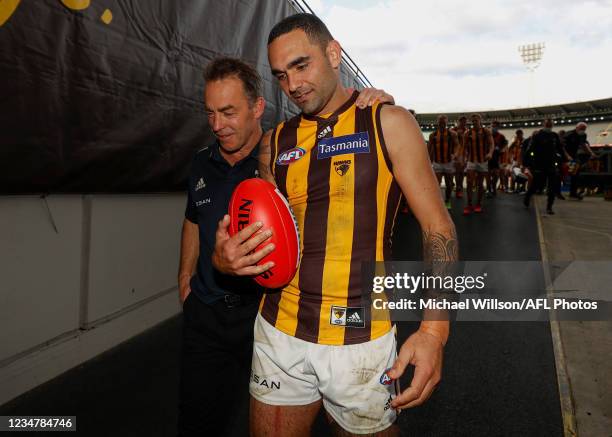 Alastair Clarkson, Senior Coach of the Hawks and Shaun Burgoyne of the Hawks leave the field for the last time during the 2021 AFL Round 23 match...