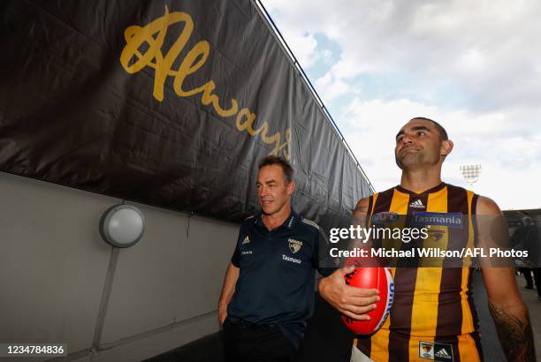 Alastair Clarkson, Senior Coach of the Hawks and Shaun Burgoyne of the Hawks leave the field for the last time during the 2021 AFL Round 23 match...