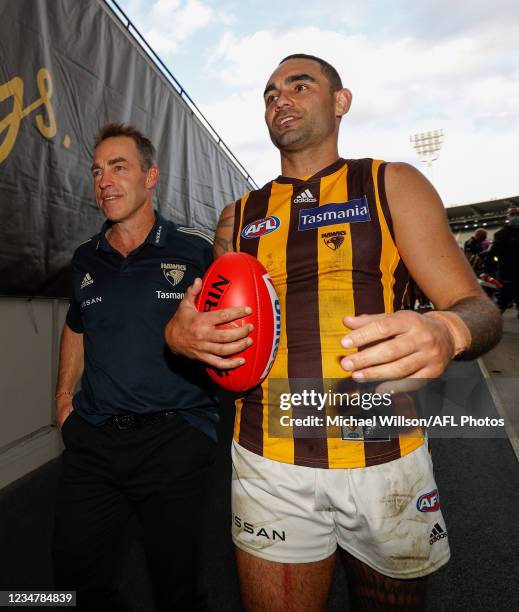 Alastair Clarkson, Senior Coach of the Hawks and Shaun Burgoyne of the Hawks leave the field for the last time during the 2021 AFL Round 23 match...