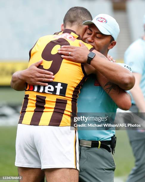 Shaun Burgoyne of the Hawks and David Rodan embrace during the 2021 AFL Round 23 match between the Richmond Tigers and the Hawthorn Hawks at the...